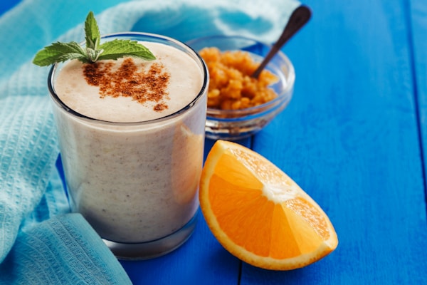 Orange milkshake with cinnamon and mint